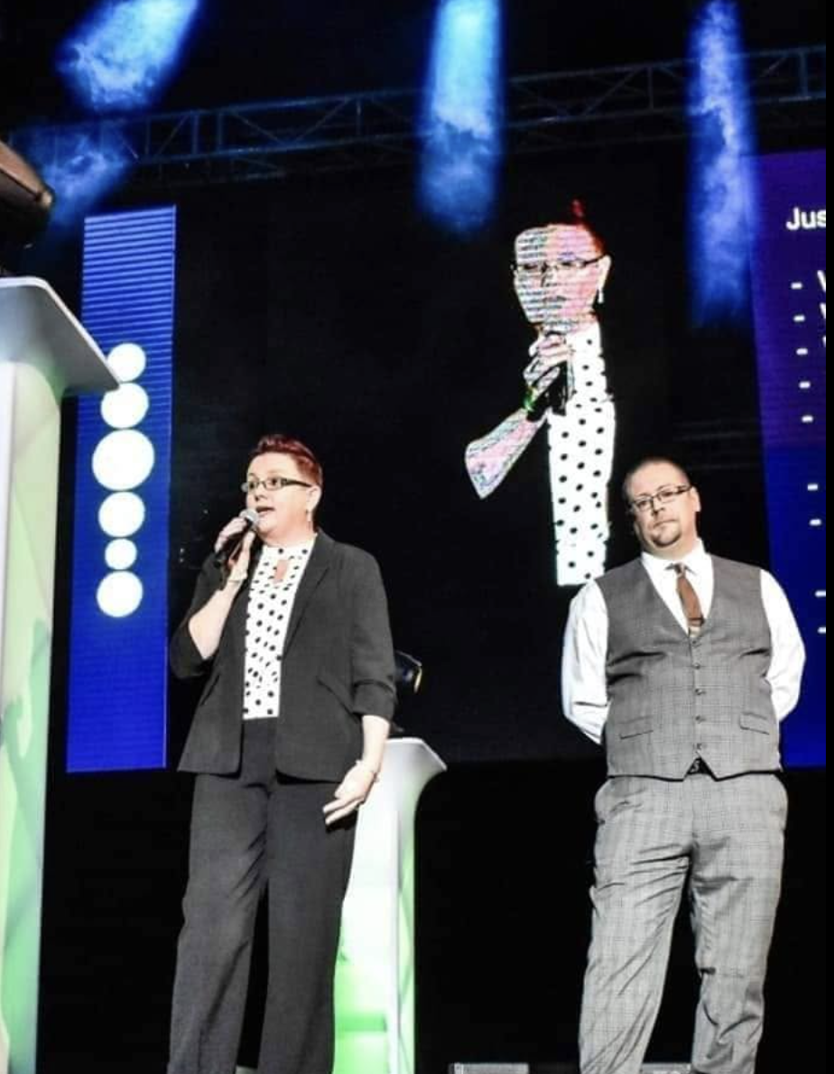 Justine and Phil speaking on stage